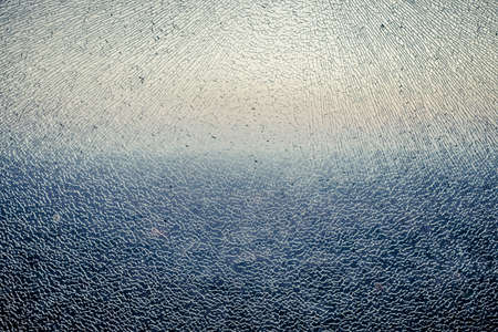 Cracks on glass texture. Shattered glass with color gradientの写真素材