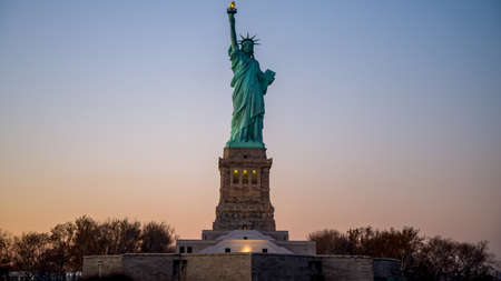New York, USA - November 2012: Statue of Liberty during sunset in the eveningの写真素材
