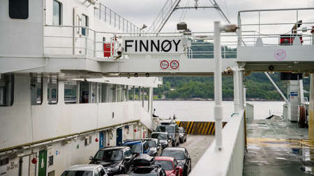 Norway -  May 2016: Ferry boat transporting cars and sailing in a Norwegian fjord
