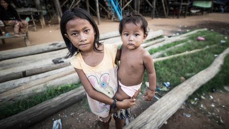 Tonle Sap Lake, Cambodia - December 2015: Young girl and his small brother at floating village of Komprongpok at Tonle Sap lakeのeditorial素材