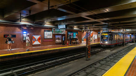 San Francisco, California, USA - August 2019: Muni subway train arriving at Castro station while commuters waiting at stationのeditorial素材