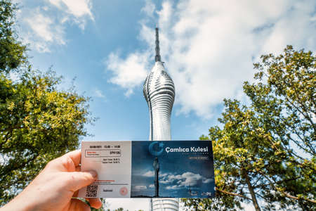 Camlica, Istanbul, Turkey - September 2021: Hand holding entrance ticket to Kucuk Camlica TV Radio Tower. Camlica Communications Tower is a popular place for touristsのeditorial素材