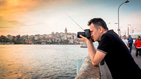 Istanbul, Turkey - May 2013: Photographer photographing Istanbul during sunset in Eminonu district. Istanbul is one of the top tourist destinations in the world.のeditorial素材