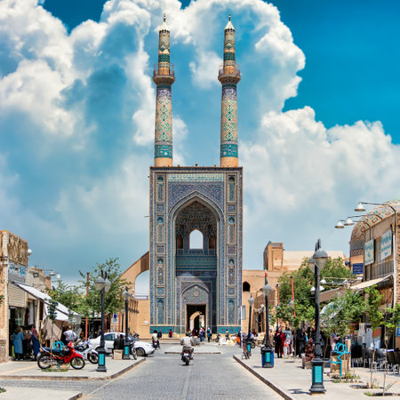 Yazd, Iran - May 2019: Local people and tourists around the gate and minarets of Jameh Mosque of Yazd. Jameh Mosque of Yazd is the grand, congregational mosque of Yazd cityのeditorial素材