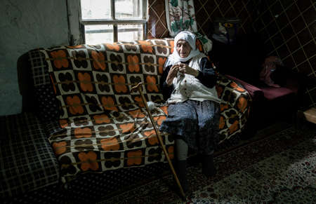 Artvin, Turkey - July 2016: Woman dressed in traditional clothes knitting in Artvin, the Black Sea region, Turkeyのeditorial素材