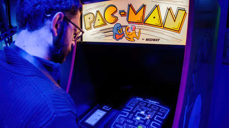Istanbul, Turkey - February 2016: Man playing with pac-man arcade console machine cabinetのeditorial素材