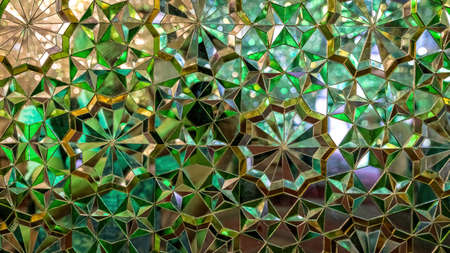 Shiraz, Iran - May 2019: Interior design of Shah-e-Cheragh complex Shrine and mausoleum, the mirror mosque, decorated in green with numerous mirrors.のeditorial素材