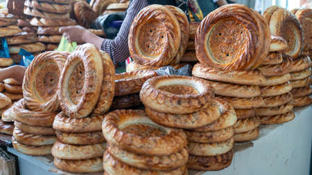 Naan circular and flat bread made in a tandoori oven, a central Asian custom, Osh local bazaar, Kyrgyzstan.の写真素材