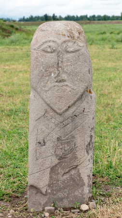 Historical stone sculptures near Old Burana tower that depict various figures and scenes from Kyrgyz history and culture. These sculptures provide insight into country's rich history and traditionsの写真素材