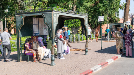 Marrakech, Morocco - 15 September 2022: Local Moroccan people waiting at the bus stop for public transportation bus in city center downtownのeditorial素材