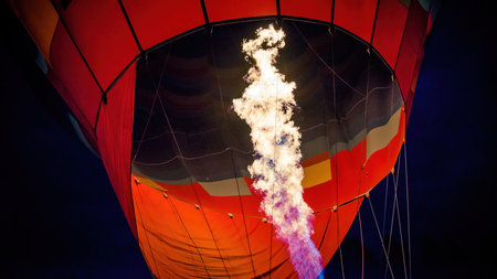 A hot air balloon being hot air filled with flames before sunrise. Close up of burner flame during balloon glow at night in Goreme, Cappadocia, Turkeyの写真素材