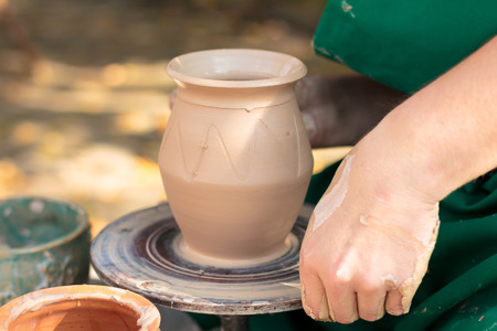 Potter shaping clay jugの写真素材