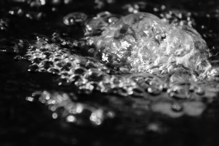 Abstract splashes of water on a black backgroundの写真素材