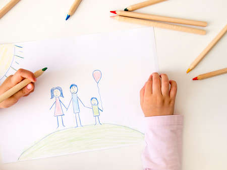 Child drawing a happy familyの写真素材