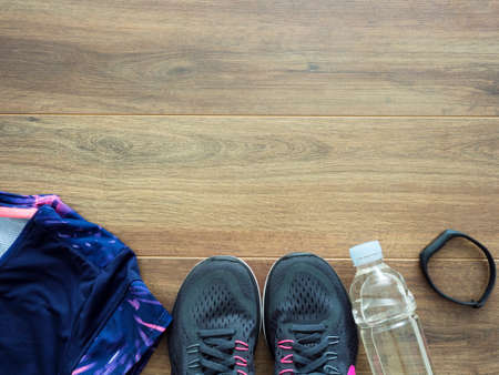 Running equipment over wooden background, top viewの写真素材