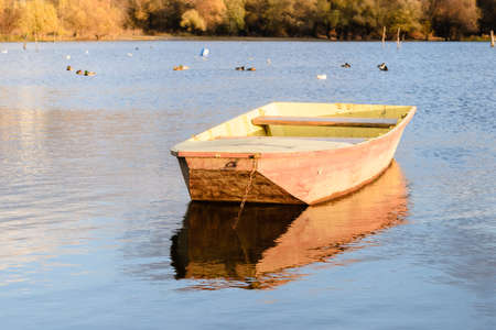Moored wooden fishing boats on the banks of the Danube tributary.