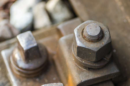 Old rusty screws on wooden railway sleepers