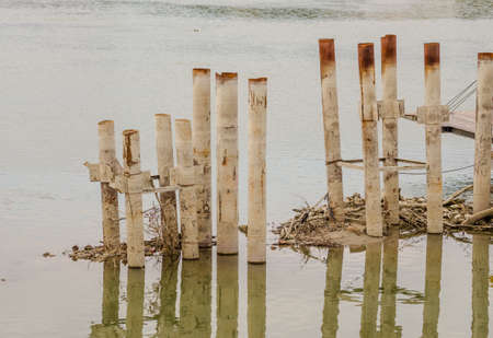 The pillars of the former bridge overlooking the waters of the Danube.の写真素材