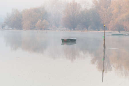 A forgotten fishing boat in the tributary of the Danube near Novi Sad, Serbia.の写真素材