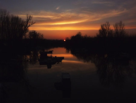 A panoramic view of the autumn sunset over the backwaters of the Danube River. A panoramic view of the backwater of the Danube river in the autumn period of the day.の写真素材