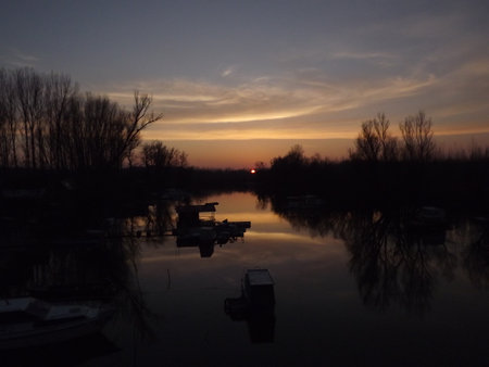 A panoramic view of the autumn sunset over the backwaters of the Danube River. A panoramic view of the backwater of the Danube river in the autumn period of the day.の写真素材