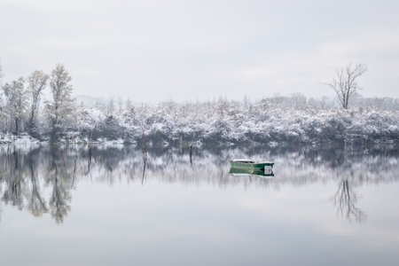 Marsh lake in winter covered with snow. Winter landscape of a marshy lake covered with snow and ice.の写真素材