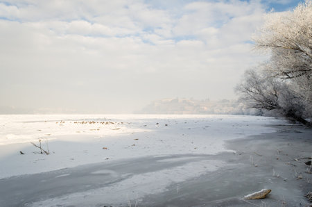 Frozen, snow-covered banks of the Danube River below the Petrovaradin Fortress, Vojvodina, Novi Sad, Petrovaradin, Serbia.の写真素材