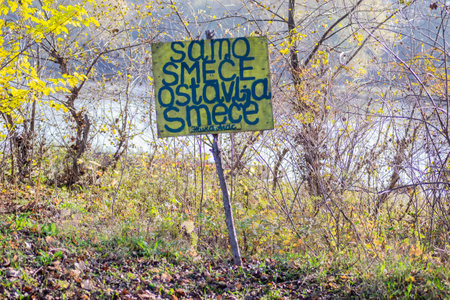 Wooden warning sign, at the entrance to the forest.の写真素材