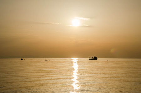 Fishing boat on the high seas, in the early morning hours in Leptokarya,Greece.の写真素材