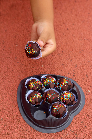 Children are taken in hand sweets to eat.の写真素材