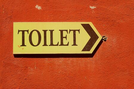 toilet vintage label on a brown background.の写真素材