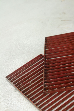 steel grating red on a white background.の写真素材