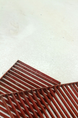 steel grating red on a white background.の写真素材