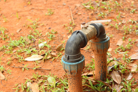 A water pipes on the green grassの写真素材
