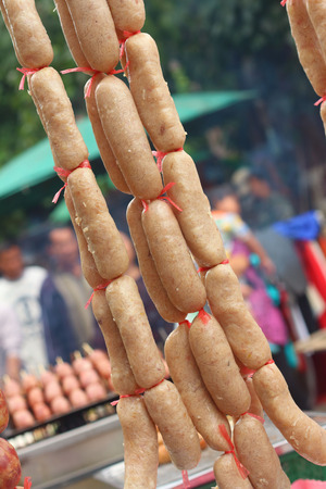 BBQ sausages on the grill in the marketの写真素材