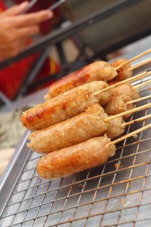 BBQ sausages on the grill in the marketの写真素材