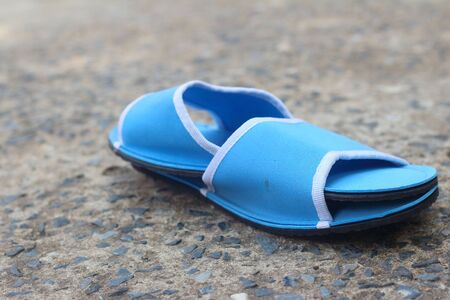 Slippers blue on a background of cement.の写真素材