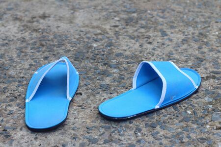 Slippers blue on a background of cement.の写真素材