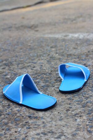 Slippers blue on a background of cement.の写真素材