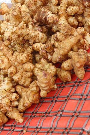 Ginger root on a table in the marketの写真素材