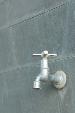 faucet on a gray background at the toiletの写真素材
