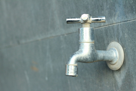 faucet on a gray background at the toiletの写真素材