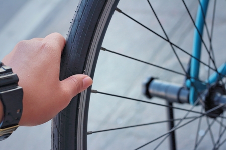 Wrings hands on the wheel of the bike.の写真素材