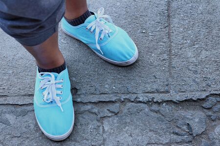 Woman wearing blue shoes at the park.