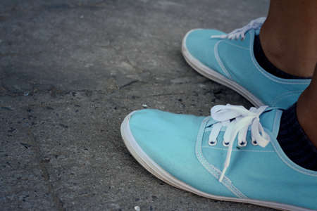 Woman wearing blue shoes at the park.
