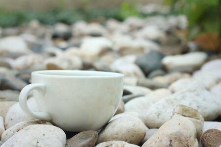 Coffee in a white cup on a background of white stone.の写真素材