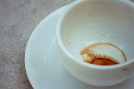 Coffee white cup is then used on a background of cementの写真素材
