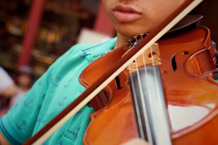 Musician playing violin melodically at the parkの写真素材