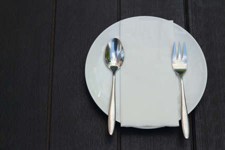 White dish with a spoon and fork.の写真素材