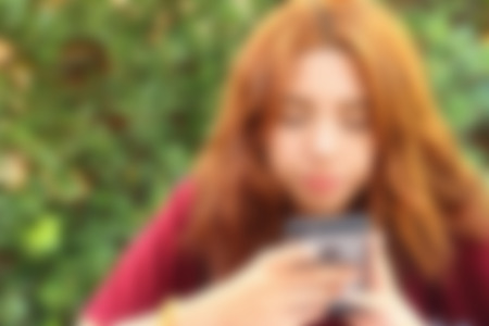 blurred of women  is using a phoneの写真素材